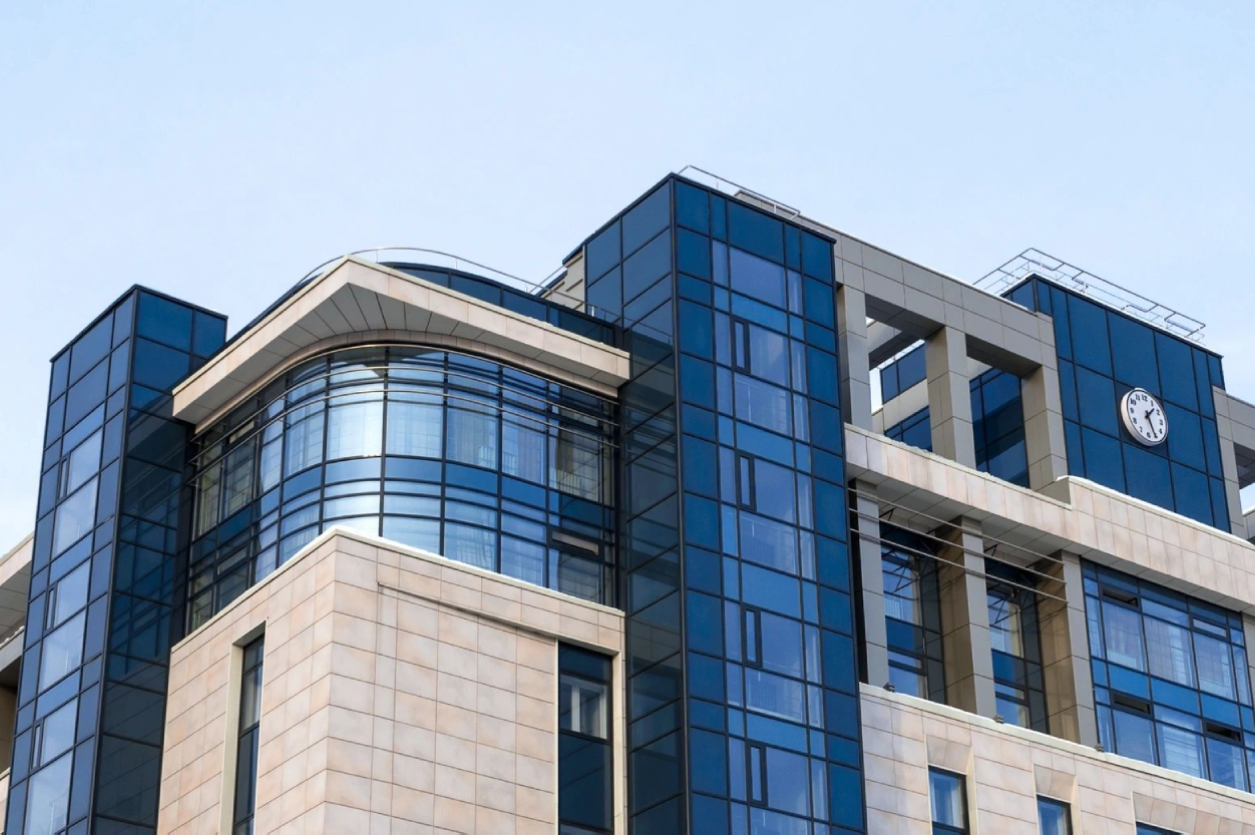 Building with blue glass and a clock